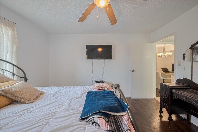 1505 Ward Rd Unit 118, Baytown, TX 77520 - bedroom with wood finished floors, a textured ceiling, a desk, a ceiling fan, and a chandelier