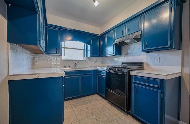 170 Pine Mdws, Hempstead, TX 77445 - kitchen with black electric range, blue cabinets, under cabinet range hood, and light tile patterned flooring