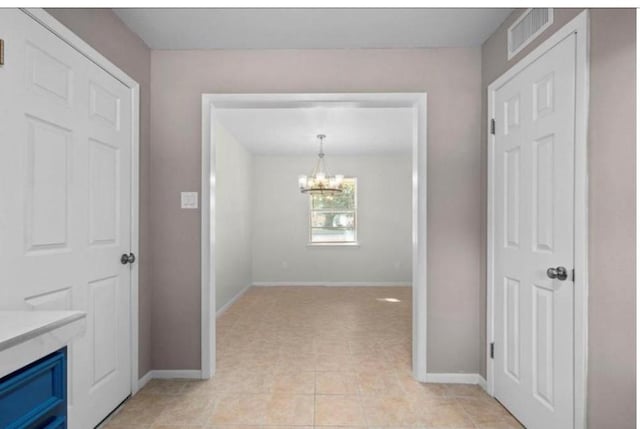 170 Pine Mdws, Hempstead, TX 77445 - corridor featuring a chandelier and light tile patterned floors