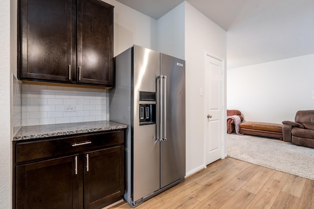 1166 Magnolia Branch Ln, Tomball, TX 77375 - kitchen featuring high end refrigerator, light wood-style flooring, open floor plan, stone countertops, and dark brown cabinets