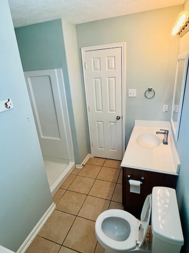 14088 Running Bear Dr, Willis, TX 77378 - full bath with vanity, tile patterned floors, a textured ceiling, and a shower