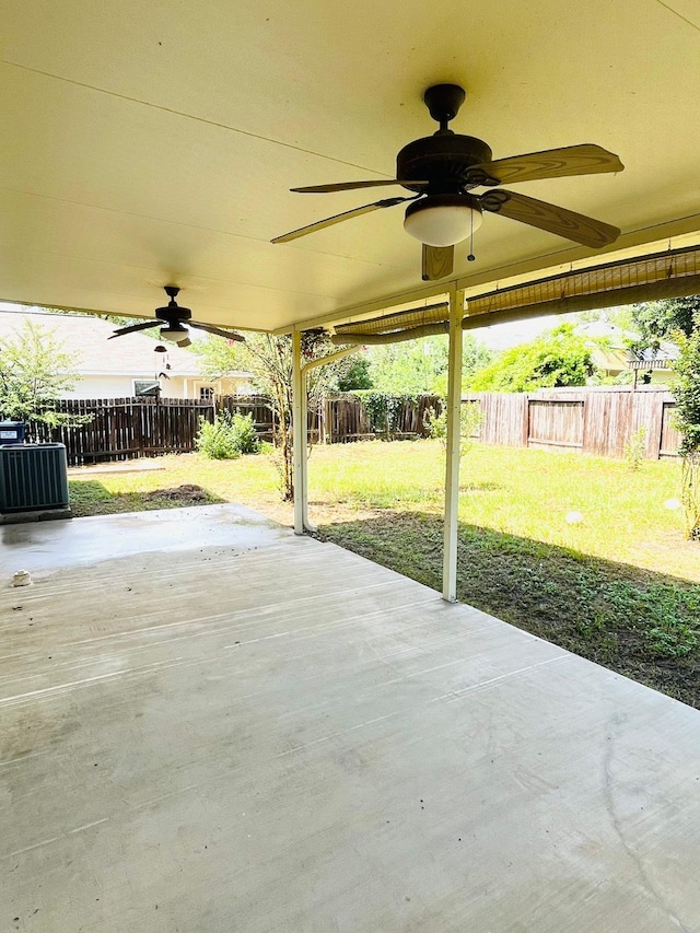 14088 Running Bear Dr, Willis, TX 77378 - fenced backyard with a ceiling fan and a patio area