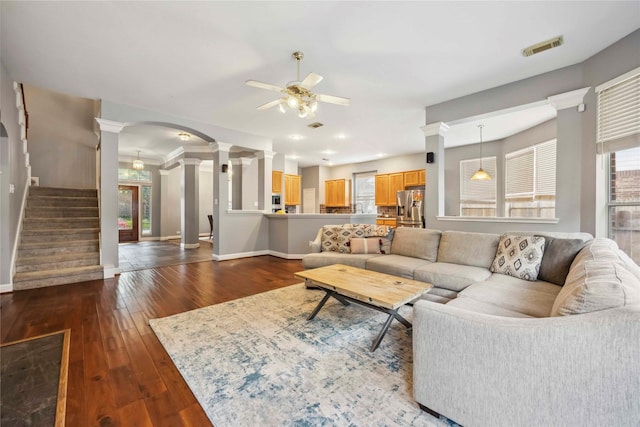 5715 Ashley Spring Ct, Katy, TX 77494 - living room featuring ornate columns, a ceiling fan, dark wood finished floors, and stairs
