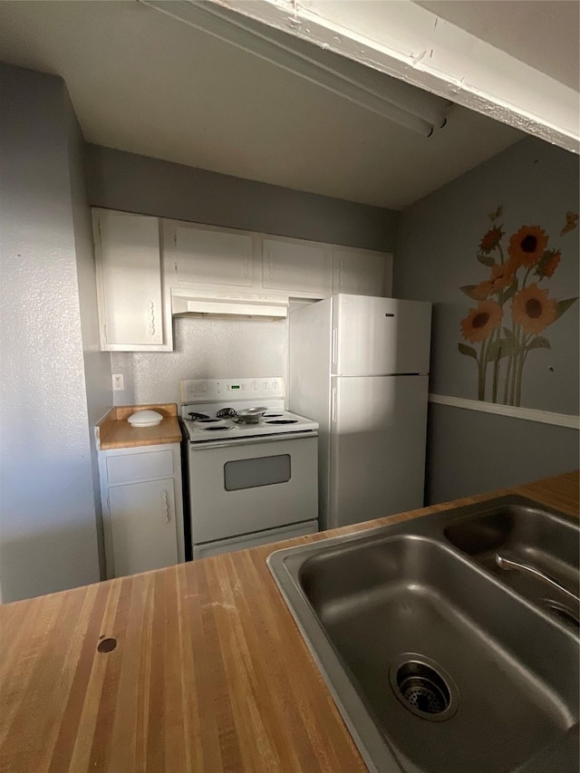 7200 Clarewood Dr Unit 10, Houston, TX 77036 - kitchen with white appliances, white cabinetry, wood counters, and under cabinet range hood