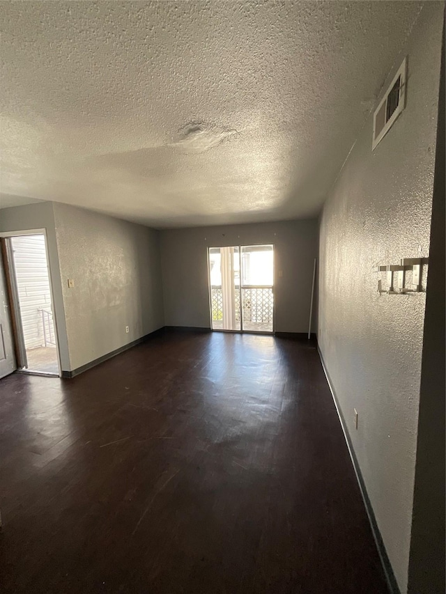 7200 Clarewood Dr Unit 10, Houston, TX 77036 - unfurnished room with a textured wall, a textured ceiling, and wood finished floors