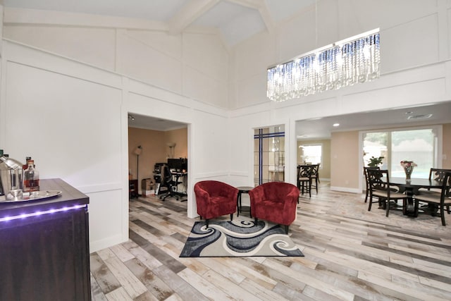 5422 Jason St, Houston, TX 77096 - living area featuring light wood-type flooring, high vaulted ceiling, a desk, and beam ceiling