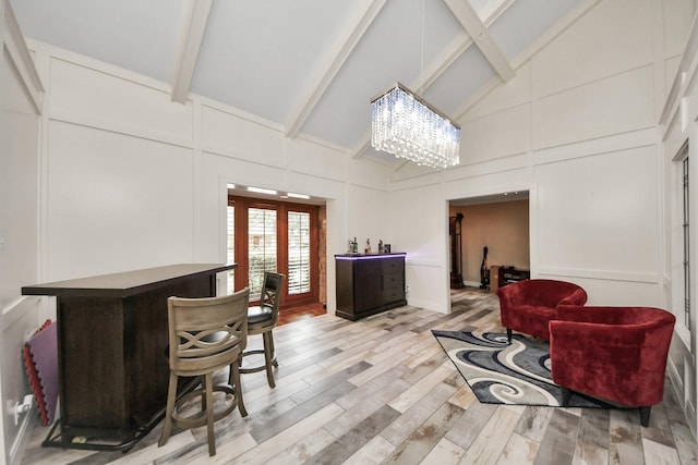 5422 Jason St, Houston, TX 77096 - interior space featuring high vaulted ceiling, beam ceiling, a chandelier, light wood-style flooring, and a bar