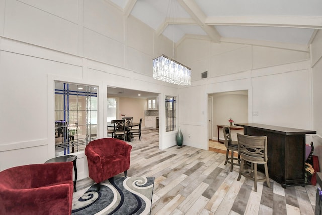 5422 Jason St, Houston, TX 77096 - living room featuring high vaulted ceiling, light wood-type flooring, and beamed ceiling