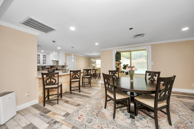 5422 Jason St, Houston, TX 77096 - dining room featuring ornamental molding, recessed lighting, and light wood-style flooring