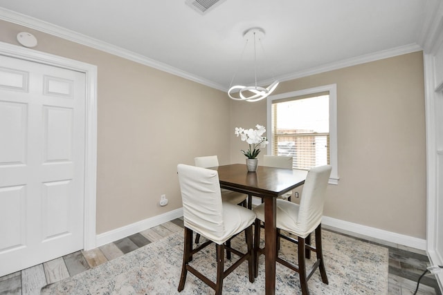 5422 Jason St, Houston, TX 77096 - dining space with a chandelier, crown molding, and light wood finished floors