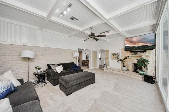 5422 Jason St, Houston, TX 77096 - living room featuring brick wall, a ceiling fan, coffered ceiling, carpet flooring, and beam ceiling
