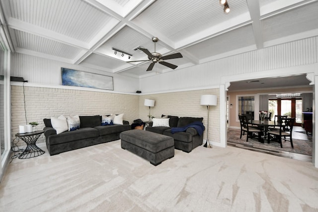 5422 Jason St, Houston, TX 77096 - carpeted living area featuring brick wall, a ceiling fan, and beam ceiling