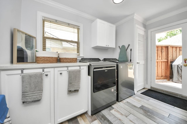 5422 Jason St, Houston, TX 77096 - laundry room featuring cabinet space, washer and dryer, light wood-type flooring, and ornamental molding