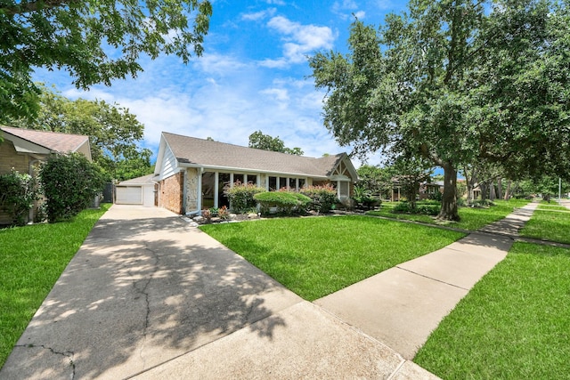 5422 Jason St, Houston, TX 77096 - view of front of property featuring a front yard, a detached garage, and brick siding