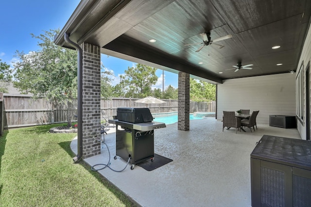 31276 New Forest Park Ln, Spring, TX 77386 - fenced backyard with area for grilling, a ceiling fan, a patio area, and outdoor dining space