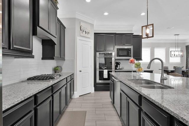 31276 New Forest Park Ln, Spring, TX 77386 - kitchen with appliances with stainless steel finishes, crown molding, light stone counters, pendant lighting, and backsplash