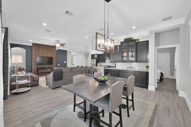 31276 New Forest Park Ln, Spring, TX 77386 - dining area featuring ornamental molding, a ceiling fan, recessed lighting, a chandelier, and wood tiled floors
