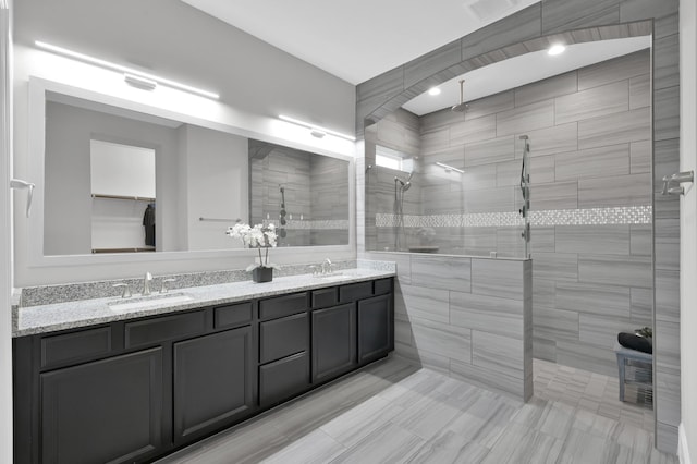 31276 New Forest Park Ln, Spring, TX 77386 - bathroom featuring a tile shower and double vanity