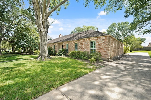 3103 Fairway Dr, Sugar Land, TX 77478 - view of front of house with brick siding, a front lawn, a chimney, and a shingled roof