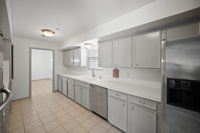 3103 Fairway Dr, Sugar Land, TX 77478 - kitchen with appliances with stainless steel finishes, light countertops, light tile patterned floors, and gray cabinetry