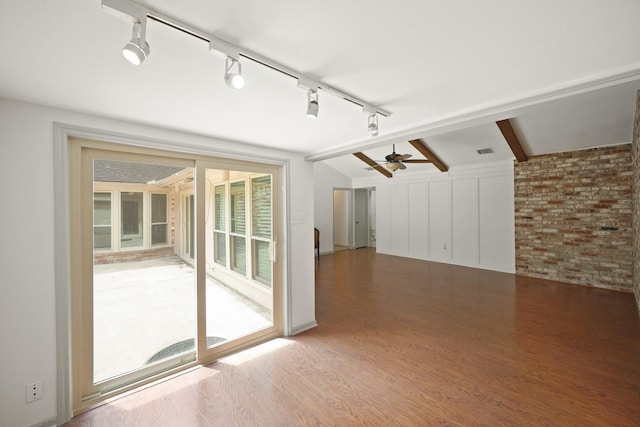 3103 Fairway Dr, Sugar Land, TX 77478 - unfurnished living room with a ceiling fan, wood finished floors, track lighting, and brick wall