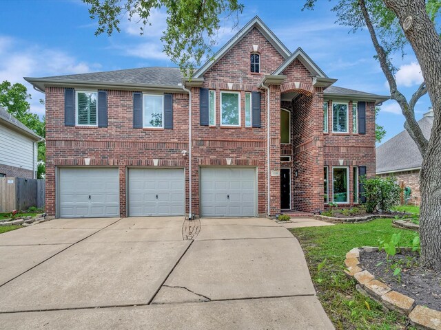 3219 Almond Creek Dr, Houston, TX 77059 - traditional-style house with brick siding, driveway, a garage, and roof with shingles