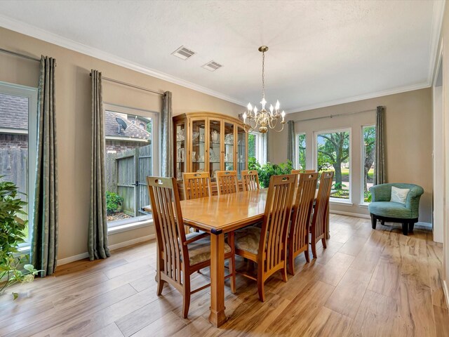 3219 Almond Creek Dr, Houston, TX 77059 - dining area with light wood finished floors, a chandelier, and ornamental molding
