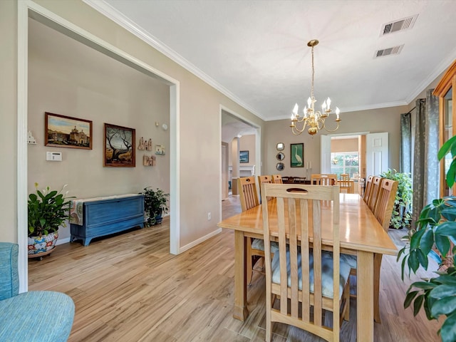 3219 Almond Creek Dr, Houston, TX 77059 - dining space featuring a chandelier, light wood-type flooring, and crown molding