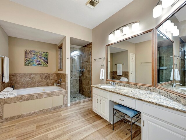 3219 Almond Creek Dr, Houston, TX 77059 - full bath with a stall shower, a garden tub, vanity, and wood finished floors