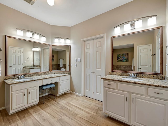 3219 Almond Creek Dr, Houston, TX 77059 - bathroom with two vanities and wood finished floors