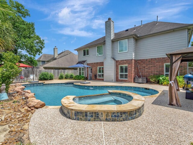 3219 Almond Creek Dr, Houston, TX 77059 - view of swimming pool with a gazebo, a patio area, and a pool with connected hot tub