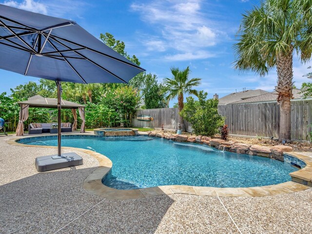 3219 Almond Creek Dr, Houston, TX 77059 - view of pool with a gazebo, an outdoor hangout area, a fenced backyard, a patio, and a pool with connected hot tub