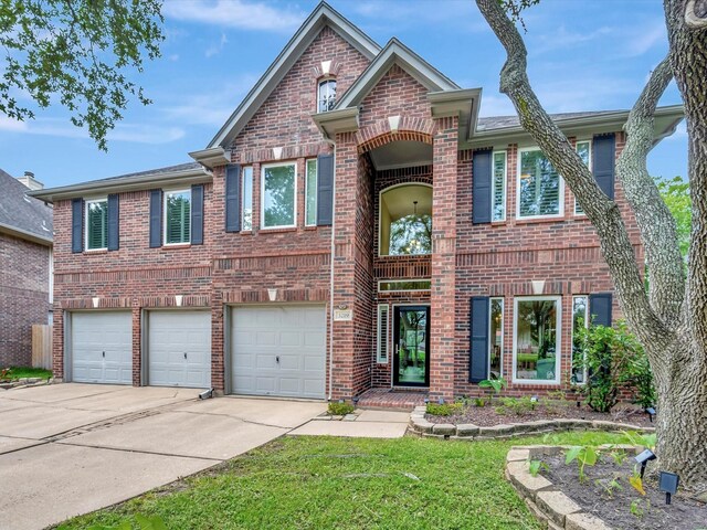 3219 Almond Creek Dr, Houston, TX 77059 - view of front of home featuring brick siding, concrete driveway, a garage, a front yard, and a balcony