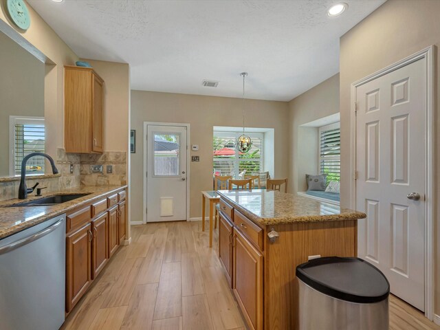 3219 Almond Creek Dr, Houston, TX 77059 - kitchen featuring stainless steel dishwasher, light wood-type flooring, light stone countertops, tasteful backsplash, and recessed lighting