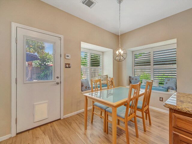 3219 Almond Creek Dr, Houston, TX 77059 - dining room featuring light wood finished floors and a chandelier