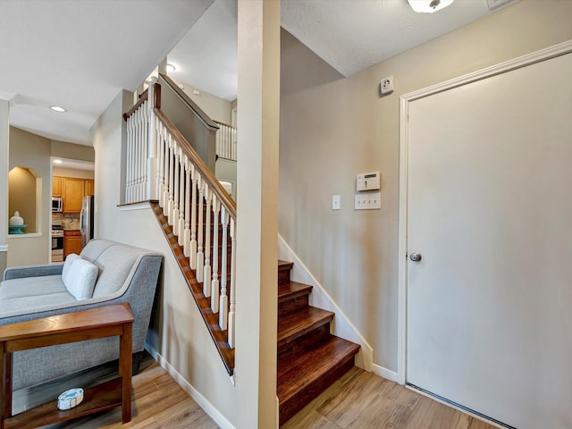3219 Almond Creek Dr, Houston, TX 77059 - stairway with wood finished floors and recessed lighting