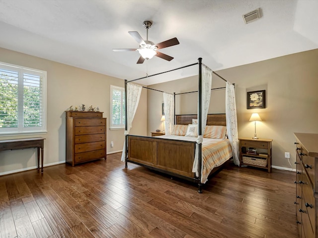 3219 Almond Creek Dr, Houston, TX 77059 - bedroom featuring multiple windows, dark wood-style floors, and a ceiling fan