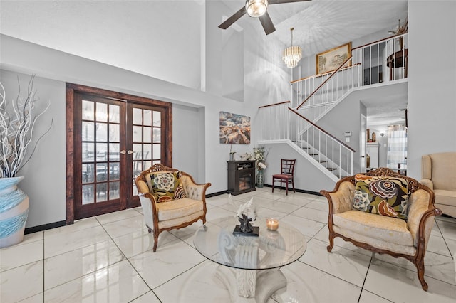 19922 Big Timber Dr, Humble, TX 77346 - living room with a high ceiling, stairway, french doors, and a ceiling fan