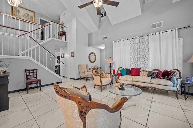 19922 Big Timber Dr, Humble, TX 77346 - living area with marble finish flooring, a towering ceiling, ceiling fan, and stairs