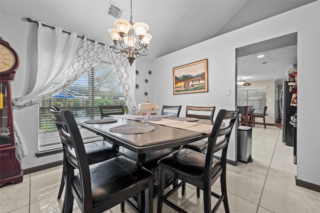 19922 Big Timber Dr, Humble, TX 77346 - dining area featuring lofted ceiling, a chandelier, and light marble finish flooring