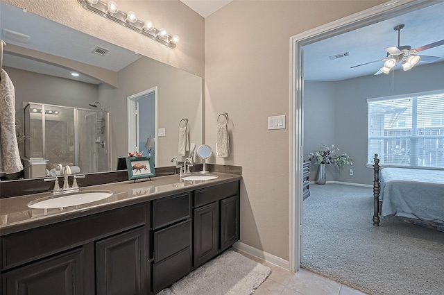 9107 Solvista Pass Ln, Houston, TX 77070 - bathroom featuring double vanity, a stall shower, ensuite bath, ceiling fan, and tile patterned flooring