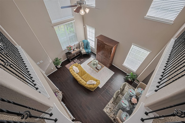 9107 Solvista Pass Ln, Houston, TX 77070 - living room featuring a high ceiling, ceiling fan, wood finished floors, and stairs