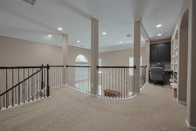 9107 Solvista Pass Ln, Houston, TX 77070 - hallway with light colored carpet, a desk, and recessed lighting