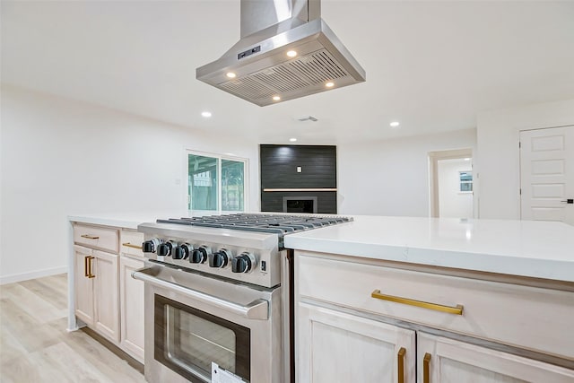 7226 Troulon Dr, Houston, TX 77074 - kitchen featuring stainless steel stove, extractor fan, light countertops, light wood-style floors, and recessed lighting