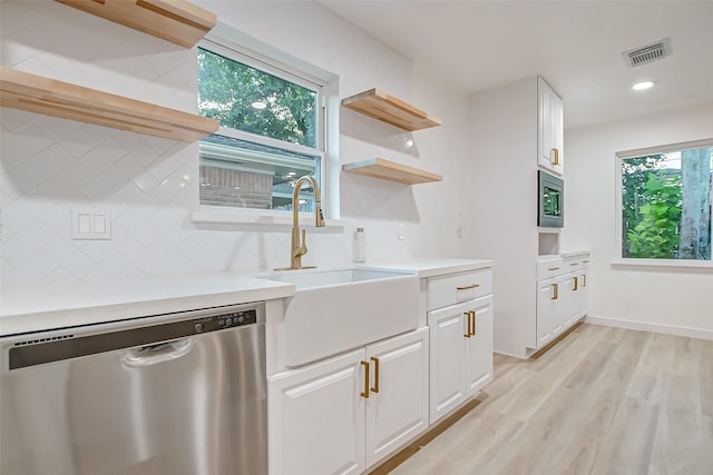 7226 Troulon Dr, Houston, TX 77074 - kitchen featuring appliances with stainless steel finishes, open shelves, decorative backsplash, white cabinets, and light wood-style floors