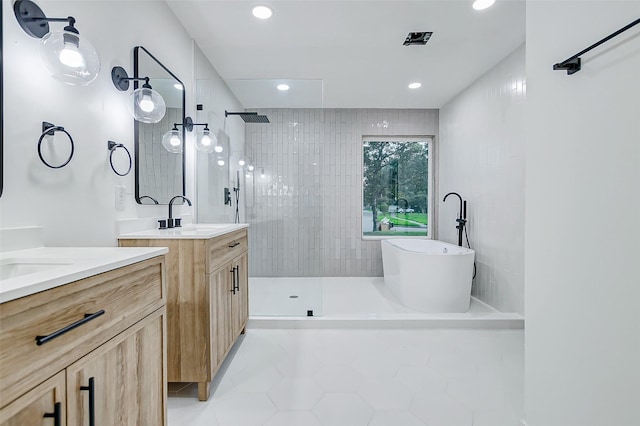 7226 Troulon Dr, Houston, TX 77074 - bathroom featuring a walk in shower, two vanities, a soaking tub, tile patterned floors, and recessed lighting