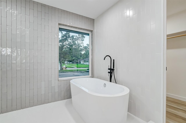 7226 Troulon Dr, Houston, TX 77074 - bathroom with a soaking tub and wood finished floors