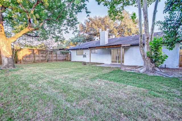 7226 Troulon Dr, Houston, TX 77074 - back of property featuring a chimney, a fenced backyard, and brick siding