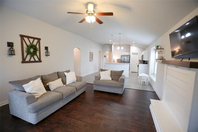 6926 Glenmoor Dr, Rosharon, TX 77583 - living room with arched walkways, vaulted ceiling, a ceiling fan, and wood finished floors