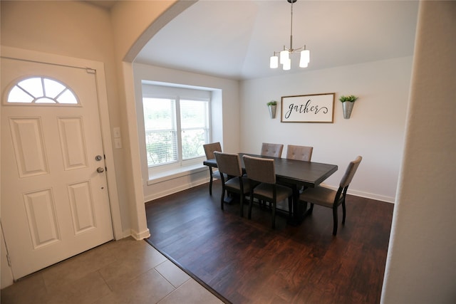 6926 Glenmoor Dr, Rosharon, TX 77583 - dining area with arched walkways, a chandelier, dark tile patterned floors, and vaulted ceiling